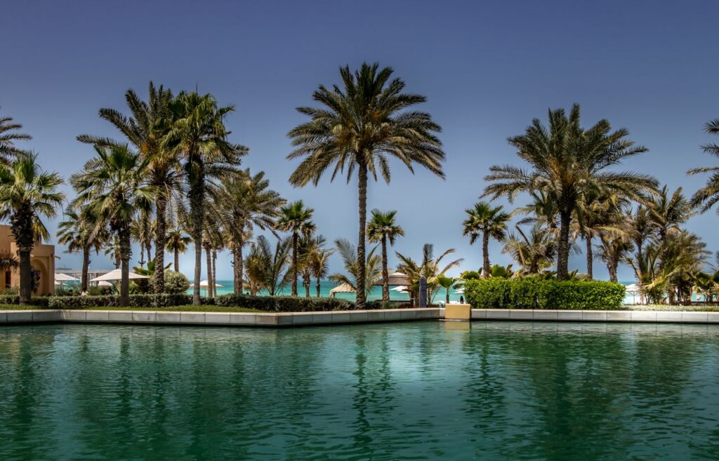 Tranquil resort with palm trees and pool overlooking the beach in Dubai.