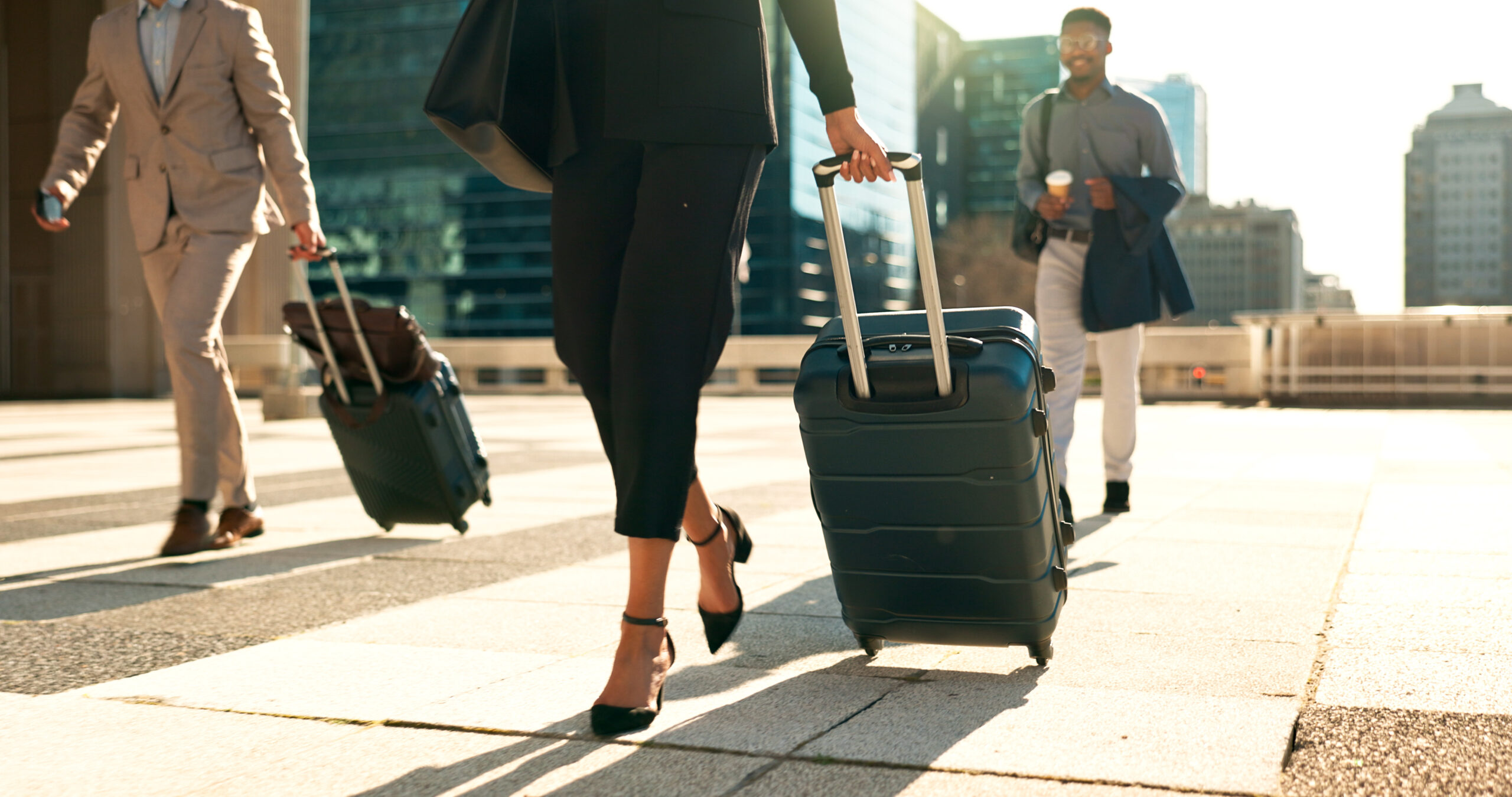 business professionals walking with luggage in urb 2026 09 24 14 45 12 utc
