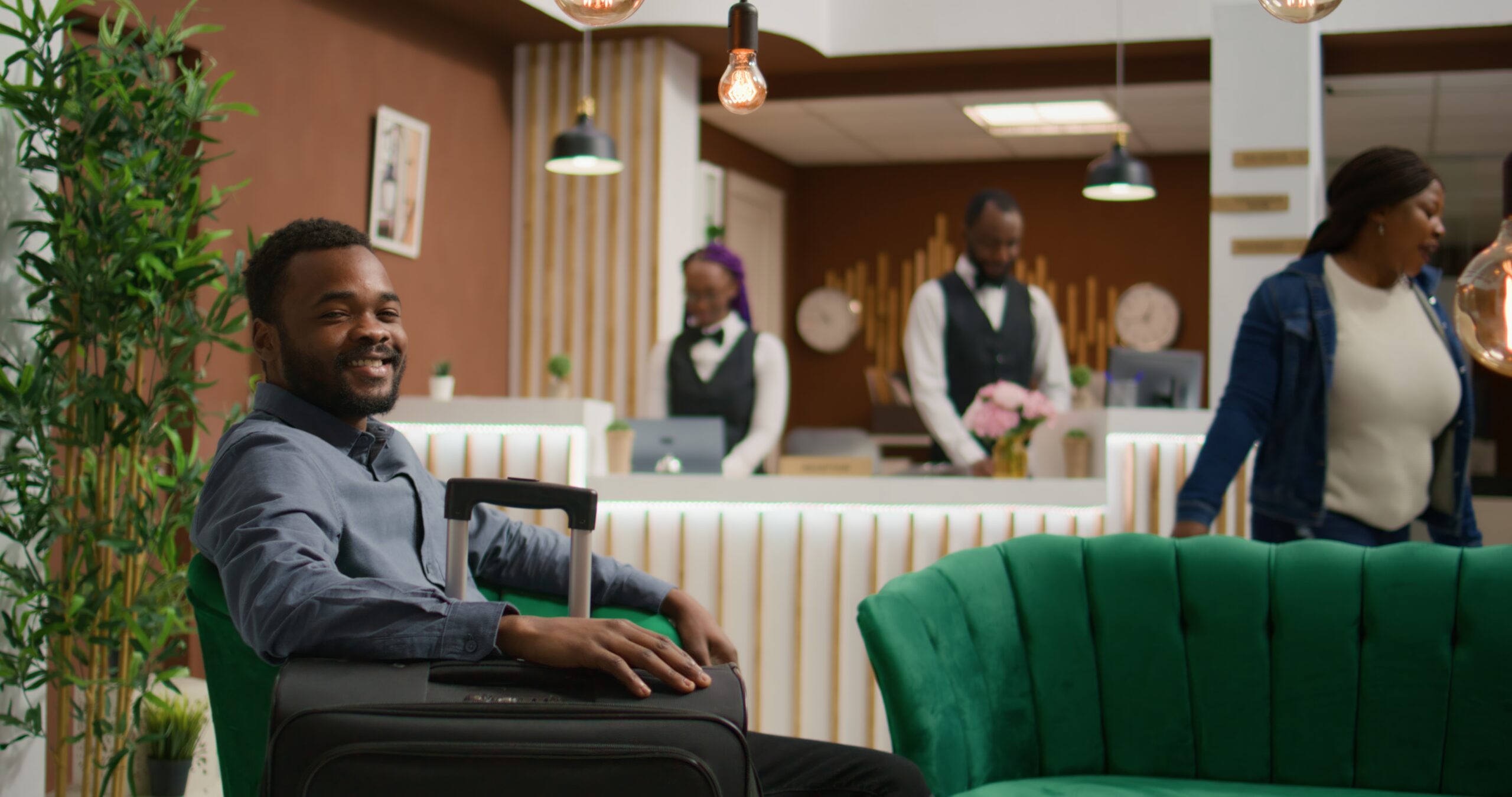 hotel guest waits in lobby for check in
